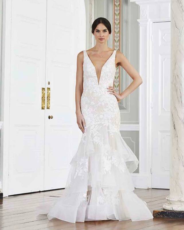 Full length frontal view of white fishtail style wedding dress